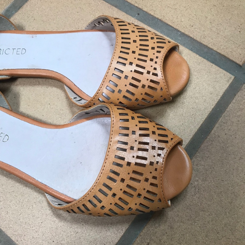 Butterscotch faux leather slip on shoes.
